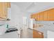 Kitchen featuring white appliances, wooden cabinets, light countertops and wood-look flooring at 327 Awendaw Cir, Ellenwood, GA 30294