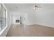Spacious living room featuring wood floors, a fireplace, and large windows providing ample natural light and lush backyard views at 327 Awendaw Cir, Ellenwood, GA 30294