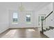 Sun-filled formal room featuring a decorative chandelier, pristine white walls, and wood-look floors at 327 Awendaw Cir, Ellenwood, GA 30294
