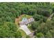 Aerial view of home, surrounded by lush greenery, features a pool and long driveway at 425 Chadwick Pl, Canton, GA 30114