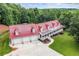Stunning aerial view of estate featuring a red roof, long porch, and mature trees at 425 Chadwick Pl, Canton, GA 30114