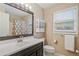 Well-lit bathroom featuring a large mirror, vanity storage, and a shower with a curtain at 425 Chadwick Pl, Canton, GA 30114
