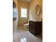 This bathroom features tile flooring, modern fixtures, an oval mirror, and a white framed window allowing natural light at 425 Chadwick Pl, Canton, GA 30114