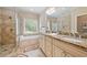 Bright bathroom featuring a tub, shower, granite countertops, and double sinks at 425 Chadwick Pl, Canton, GA 30114