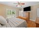 Bright bedroom with hardwood floors, ceiling fan, and door to balcony at 425 Chadwick Pl, Canton, GA 30114