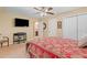 Bedroom with a ceiling fan, television, and attached bathroom, perfect for relaxation and privacy at 425 Chadwick Pl, Canton, GA 30114