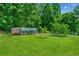 Spacious backyard featuring a chicken coop with covered run and lush green grass at 425 Chadwick Pl, Canton, GA 30114