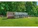 Exterior view of a chicken coop with a wire-covered run in a grassy yard at 425 Chadwick Pl, Canton, GA 30114
