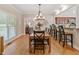 Spacious dining room with hardwood floors, a modern light fixture, and plenty of natural light at 425 Chadwick Pl, Canton, GA 30114