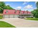 Charming home featuring a red roof, dormers, and a spacious three-car garage at 425 Chadwick Pl, Canton, GA 30114