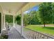 Inviting front porch with rocking chairs, ceiling fan, and views of the expansive landscaped front yard at 425 Chadwick Pl, Canton, GA 30114