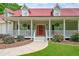 Inviting front porch with hanging plants, rocking chairs, and a bright red door at 425 Chadwick Pl, Canton, GA 30114
