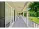 Spacious covered front porch featuring ceiling fans, grey wood-look decking, and white railings at 425 Chadwick Pl, Canton, GA 30114