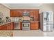 The kitchen is complete with granite countertops, stainless steel appliances, and wooden cabinets at 425 Chadwick Pl, Canton, GA 30114