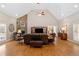 Open living room with vaulted ceilings, stone fireplace, hardwood floors, and ample seating at 425 Chadwick Pl, Canton, GA 30114