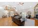 Bright living room featuring hardwood floors, a fireplace, and a staircase leading to an upper level at 425 Chadwick Pl, Canton, GA 30114