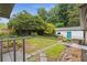The backyard boasts a manicured lawn, stone pathway, fenced perimeter, and a charming white outbuilding at 679 Creek View Dr, Lawrenceville, GA 30044