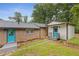 Charming backyard featuring brick house, outbuilding, stone pathway and vibrant blue doors adding a pop of color at 679 Creek View Dr, Lawrenceville, GA 30044