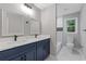 Bright bathroom featuring a double vanity with modern fixtures and a tiled shower at 679 Creek View Dr, Lawrenceville, GA 30044