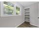 Bright bedroom with a closet and large window providing natural light and showcasing the wood-look flooring at 679 Creek View Dr, Lawrenceville, GA 30044