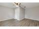 Clean bedroom with wood-look flooring, light gray walls, white trim, and a ceiling fan at 679 Creek View Dr, Lawrenceville, GA 30044