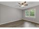 Neutral bedroom with hardwood floors, ceiling fan, and a large window at 679 Creek View Dr, Lawrenceville, GA 30044