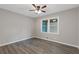 Neutral bedroom with hardwood floors, ceiling fan, and a double-hung window at 679 Creek View Dr, Lawrenceville, GA 30044