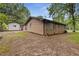 Back exterior showcasing the house and yard with an additional storage building, perfect for backyard enjoyment at 679 Creek View Dr, Lawrenceville, GA 30044