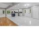 Bright, open-concept kitchen featuring white cabinets, stainless steel appliances, and a center island on bright marble floors at 679 Creek View Dr, Lawrenceville, GA 30044