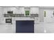 Updated kitchen featuring white cabinets, island, and modern appliances at 679 Creek View Dr, Lawrenceville, GA 30044