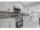 Modern kitchen with white cabinets, stainless steel appliances, and granite countertops at 679 Creek View Dr, Lawrenceville, GA 30044