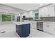 Modern kitchen with white cabinets, marble countertops, and island at 679 Creek View Dr, Lawrenceville, GA 30044
