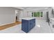 Updated kitchen with island, white cabinets, and stainless steel appliances at 679 Creek View Dr, Lawrenceville, GA 30044