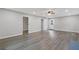 Large living room featuring a ceiling fan, wood-look flooring, white trim, and access to the backyard at 679 Creek View Dr, Lawrenceville, GA 30044