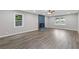 Spacious living room with a blue brick fireplace, a ceiling fan and large windows providing natural light at 679 Creek View Dr, Lawrenceville, GA 30044