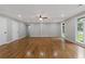 Spacious living room features hardwood flooring, recessed lighting, and large windows at 679 Creek View Dr, Lawrenceville, GA 30044