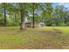 Large yard with mature trees surrounding the brick home at 679 Creek View Dr, Lawrenceville, GA 30044