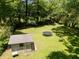 Aerial view of the backyard with a spacious lawn, trampoline, and storage shed for outdoor enjoyment at 2172 Se Wakita Se Dr, Marietta, GA 30060