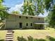 Expansive backyard featuring lush lawn, mature trees, and a covered patio perfect for outdoor relaxation at 2172 Se Wakita Se Dr, Marietta, GA 30060