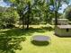 Large backyard with a trampoline, shed, and mature trees, providing ample space for outdoor activities and relaxation at 2172 Se Wakita Se Dr, Marietta, GA 30060