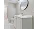 Bathroom featuring a tiled floor, a vanity, a toilet, and a round mirror at 2172 Se Wakita Se Dr, Marietta, GA 30060