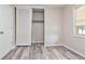 Bedroom with a sliding door closet, a window, and laminate flooring at 2172 Se Wakita Se Dr, Marietta, GA 30060
