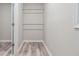 Walk in closet with neutral walls, hardwood floors and chrome bars for hanging at 2172 Se Wakita Se Dr, Marietta, GA 30060