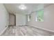 Finished room featuring laminate flooring, multiple windows, and neutral paint at 2172 Se Wakita Se Dr, Marietta, GA 30060