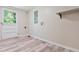 Room featuring a door to the exterior, laminate flooring, and connections for a washer and dryer at 2172 Se Wakita Se Dr, Marietta, GA 30060