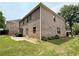 Brick exterior features a large backyard with a patio, plants, and lawn at 3389 Rosecliff Trce, Buford, GA 30519