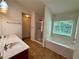 Bathroom featuring double sinks, a bathtub, and a separate glass-enclosed shower at 3389 Rosecliff Trce, Buford, GA 30519