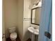 Half bathroom with a pedestal sink and a decorative mirror at 3389 Rosecliff Trce, Buford, GA 30519