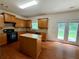 Functional kitchen with granite island, wooden cabinets, and access to a patio area at 3389 Rosecliff Trce, Buford, GA 30519