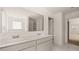 Bathroom featuring double sink vanity with a large mirror, shower, and sleek fixtures at 625 Kimberwick Dr, Locust Grove, GA 30248